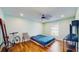 This cozy bedroom features hardwood floors, natural light, and a ceiling fan at 206 Hillcrest Dr, Safety Harbor, FL 34695