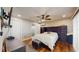 Comfortable bedroom with ceiling fan, wood floors, and closet space at 206 Hillcrest Dr, Safety Harbor, FL 34695