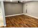 Spacious bonus room boasts beautiful hardwood floors, neutral paint and stylish ceiling fan at 206 Hillcrest Dr, Safety Harbor, FL 34695
