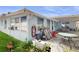 Rear of a light blue one-story home with a covered patio and various outdoor items at 206 Hillcrest Dr, Safety Harbor, FL 34695