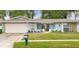 Charming single-story home featuring a well-maintained lawn and attached two-car garage at 206 Hillcrest Dr, Safety Harbor, FL 34695
