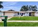 Charming single-story home featuring a well-manicured lawn, stone accents and a spacious two-car garage at 206 Hillcrest Dr, Safety Harbor, FL 34695