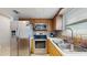 Kitchen featuring stainless steel appliances, stone backsplash, and wood cabinets at 206 Hillcrest Dr, Safety Harbor, FL 34695