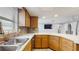 Kitchen with stainless steel sink, stone backsplash, and wood cabinetry at 206 Hillcrest Dr, Safety Harbor, FL 34695