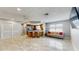 Open-concept living room with a breakfast bar, tiled flooring, and natural light at 206 Hillcrest Dr, Safety Harbor, FL 34695