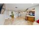 Bright living room featuring tile floors, breakfast bar, and sliding glass doors at 206 Hillcrest Dr, Safety Harbor, FL 34695