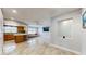 Open-concept living room boasts tile floors, kitchen bar, and abundant natural light at 206 Hillcrest Dr, Safety Harbor, FL 34695