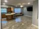 Open-concept living room with modern kitchen, stainless appliances and ceramic tile floors at 206 Hillcrest Dr, Safety Harbor, FL 34695