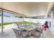 Covered outdoor patio with a dining table and chairs, perfect for entertaining at 206 Hillcrest Dr, Safety Harbor, FL 34695