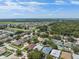 Wide aerial view of a community featuring diverse homes surrounded by trees and greenery, with lake views at 2108 Delightful Dr, Ruskin, FL 33570