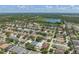 Wide aerial view of a residential area featuring a pond and expansive landscaping with mature trees at 2108 Delightful Dr, Ruskin, FL 33570