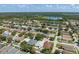 Vast aerial view of a residential community, showcasing mature trees and a serene lake at 2108 Delightful Dr, Ruskin, FL 33570