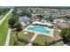 Aerial view showcasing the community pool, playground, basketball court, and surrounding neighborhood at 2108 Delightful Dr, Ruskin, FL 33570