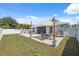 Beautiful backyard with a patio, outdoor seating, grill, and lush green lawn at 2108 Delightful Dr, Ruskin, FL 33570