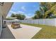 Large backyard featuring a patio area with outdoor seating and a well-maintained lawn at 2108 Delightful Dr, Ruskin, FL 33570