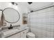 Bright bathroom with a large vanity, round mirror, and a shower-tub combo with modern fixtures at 2108 Delightful Dr, Ruskin, FL 33570