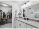Modern bathroom with an extended vanity, large mirror, and a walk-in closet, providing ample storage at 2108 Delightful Dr, Ruskin, FL 33570