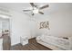 Bright bedroom with a ceiling fan, modern floors, a closet, and a delightful floral accent wall at 2108 Delightful Dr, Ruskin, FL 33570