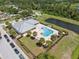Community pool area surrounded by palm trees, featuring a clubhouse and relaxing atmosphere at 2108 Delightful Dr, Ruskin, FL 33570