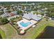 Community pool with lounging area, a lakeside view, and a well-maintained common area at 2108 Delightful Dr, Ruskin, FL 33570