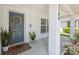 Close up on front porch with a blue door with a wreath and a welcome mat at 2108 Delightful Dr, Ruskin, FL 33570