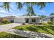 Single-story home with a two-car garage, landscaped lawn, and neutral-colored exterior at 2108 Delightful Dr, Ruskin, FL 33570