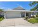 Well-maintained single-Gathering home featuring a two-car garage and manicured front lawn at 2108 Delightful Dr, Ruskin, FL 33570