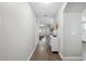 Long hallway with wood floors and a view to the bright living area at 2108 Delightful Dr, Ruskin, FL 33570