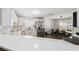 Bright kitchen features white cabinets, stainless steel appliances, and an adjacent dining area at 2108 Delightful Dr, Ruskin, FL 33570