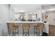 Open-concept design with bar seating connecting the kitchen to the adjacent dining area at 2108 Delightful Dr, Ruskin, FL 33570