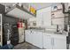Convenient laundry area with modern washer, dryer, utility sink, and cabinetry at 2108 Delightful Dr, Ruskin, FL 33570