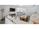 Inviting living room with stylish sofas, a media console, and a glimpse into the modern kitchen at 2108 Delightful Dr, Ruskin, FL 33570