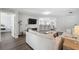 Open-concept living room with bar seating at the kitchen counter and hardwood floors at 2108 Delightful Dr, Ruskin, FL 33570