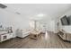 Cozy living room boasts wood-look floors, neutral colors, and a comfortable seating arrangement at 2108 Delightful Dr, Ruskin, FL 33570