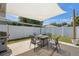 Enjoy outdoor dining on this patio with a stylish table and chairs beneath a shade sail at 2108 Delightful Dr, Ruskin, FL 33570
