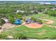 Aerial view of baseball fields, playground and park surrounded by lush trees at 238 7Th S Ave, Safety Harbor, FL 34695