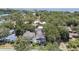 Aerial view of a residential area, lush with trees, and showing nearby cityscape at 238 7Th S Ave, Safety Harbor, FL 34695