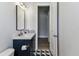 Bright bathroom boasts modern vanity with stylish fixtures, and geometric tile flooring at 238 7Th S Ave, Safety Harbor, FL 34695