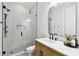 Modern bathroom featuring a glass-enclosed shower, patterned tile floors, and wood vanity at 238 7Th S Ave, Safety Harbor, FL 34695