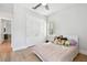 Bright bedroom with light pink bedspread, fan, window, and closet space at 238 7Th S Ave, Safety Harbor, FL 34695