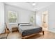 Bright bedroom with hardwood floors, a queen bed, and a view of an ensuite bathroom at 238 7Th S Ave, Safety Harbor, FL 34695