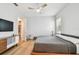 Airy bedroom featuring a queen-size bed, ceiling fan, and a view into the closet at 238 7Th S Ave, Safety Harbor, FL 34695