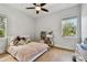 bedroom features a ceiling fan, and a window looking out at the nearby treetops at 238 7Th S Ave, Safety Harbor, FL 34695