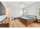 Simple bedroom featuring a queen bed, ceiling fan, and natural light from a window at 238 7Th S Ave, Safety Harbor, FL 34695
