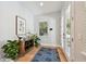Stylish foyer featuring hardwood floors, a modern console table with plants, and natural light at 238 7Th S Ave, Safety Harbor, FL 34695
