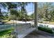 Relax on this charming front porch swing with a drink holder, overlooking the yard and quiet street at 238 7Th S Ave, Safety Harbor, FL 34695