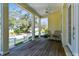 Relaxing front porch featuring wood flooring, an overhead fan, white columns and railings, and neighborhood views at 238 7Th S Ave, Safety Harbor, FL 34695