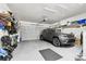 Spacious two car garage featuring ample storage, a modern vehicle, and epoxy flooring at 238 7Th S Ave, Safety Harbor, FL 34695