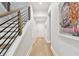 Bright hallway with wood floors and a staircase with modern railings at 238 7Th S Ave, Safety Harbor, FL 34695