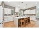 A gourmet kitchen featuring a large island with seating, white cabinets, and stainless steel appliances at 238 7Th S Ave, Safety Harbor, FL 34695